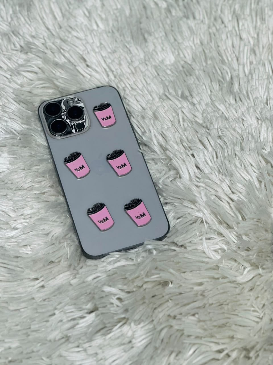 Grey phone case with pink coffee cup charms