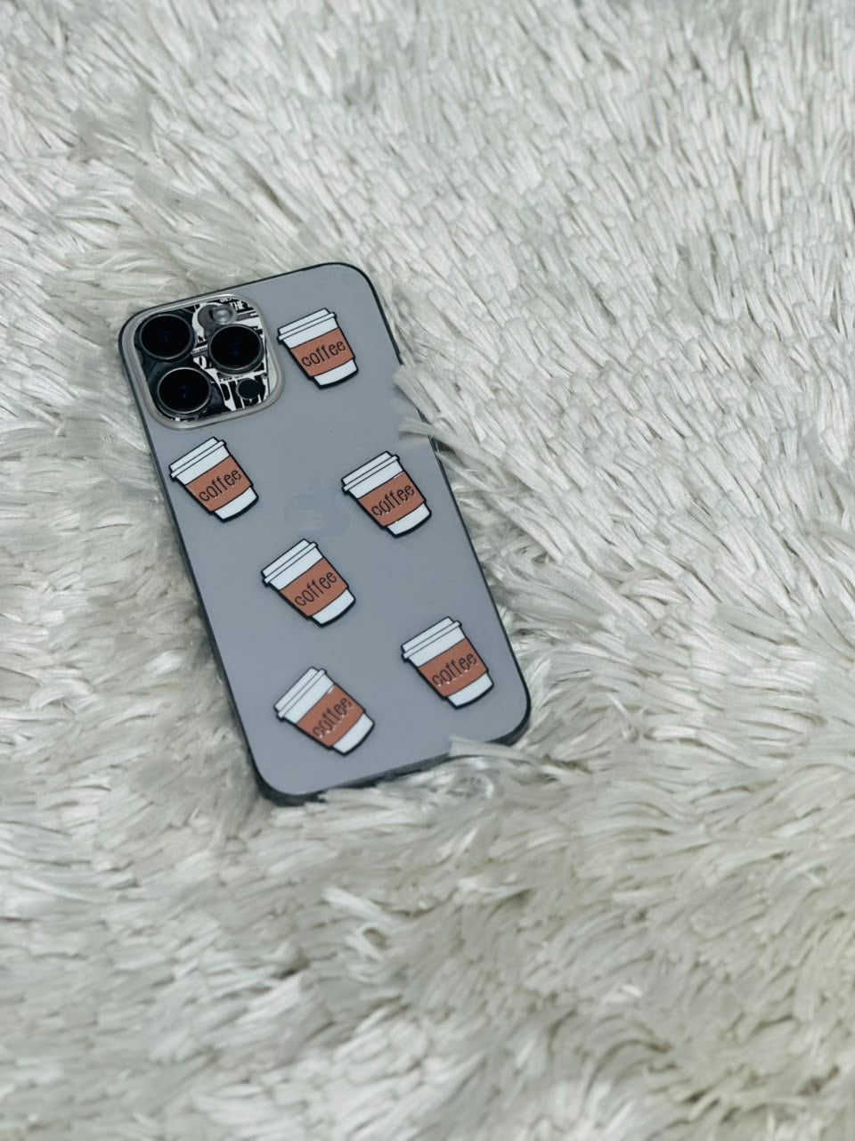 Grey phone case with white and brown coffee cup charms